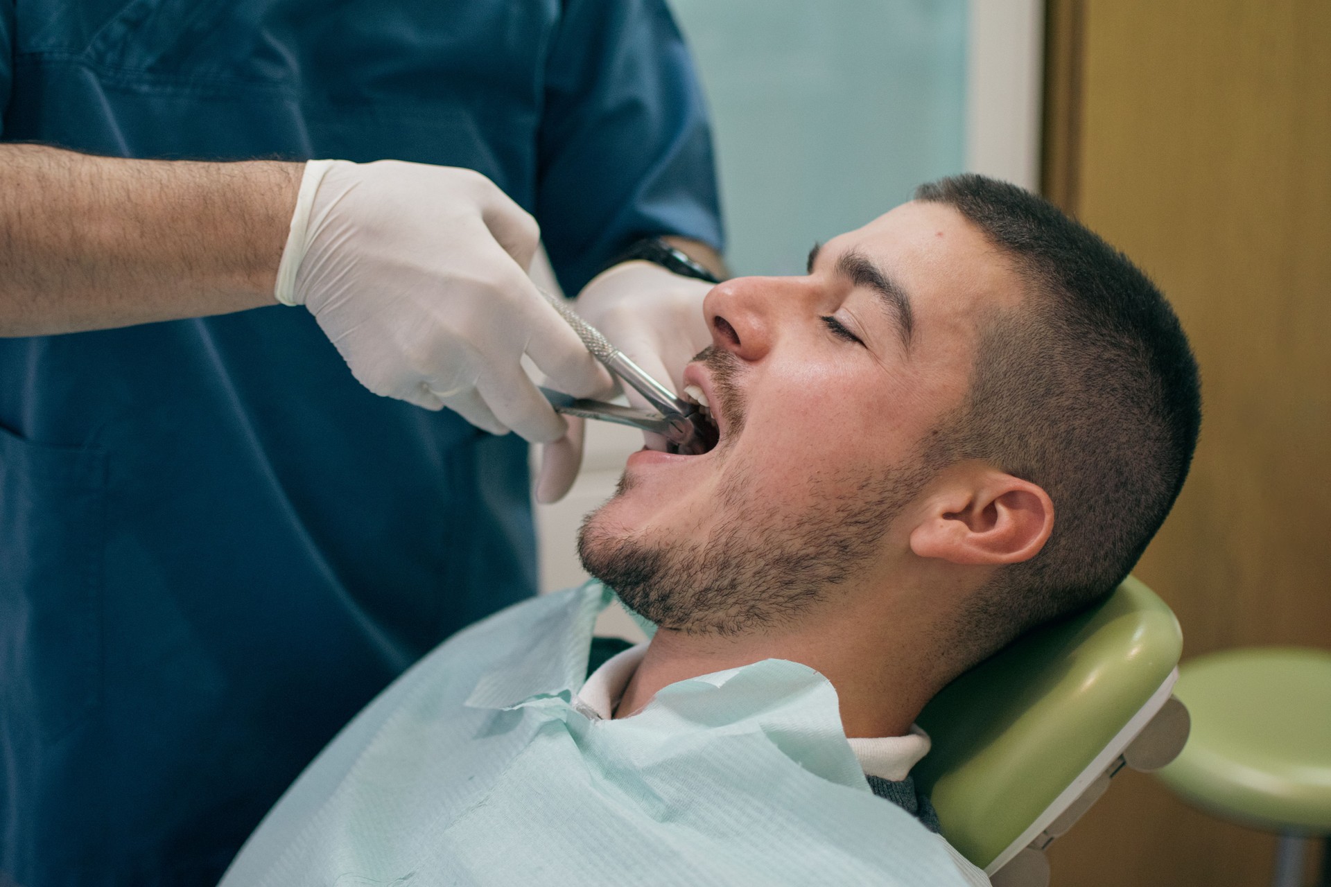tooth extraction in the dental office with forceps
